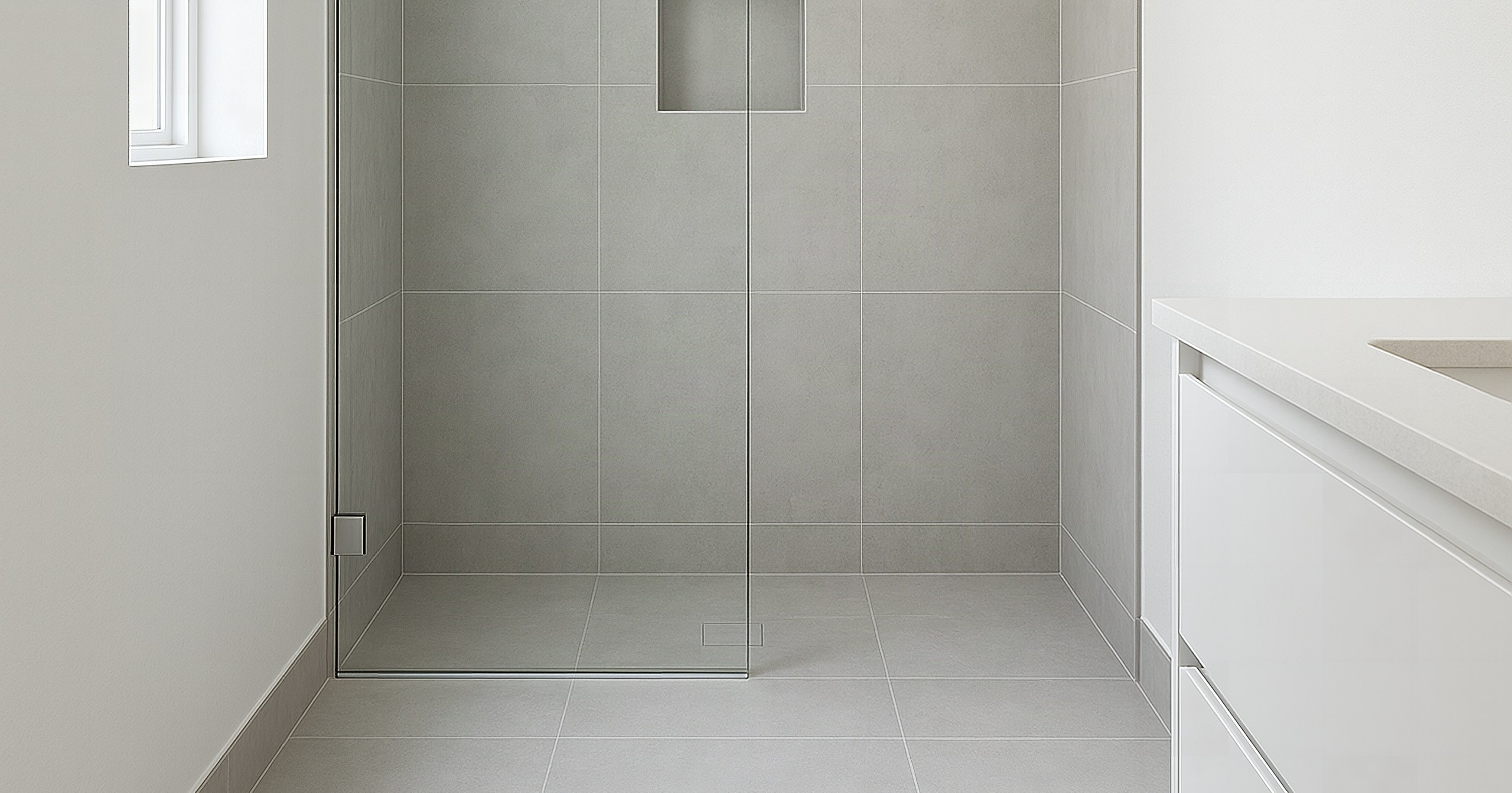 Illustrative example: the same Knoxville bathroom after remodeling, with the old tub replaced by a curbless walk-in shower in large-format gray tile
